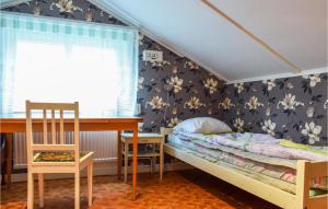 a bedroom with a bunk bed and a chair at Nice Home In Gamleby With House A Panoramic View in Gamleby