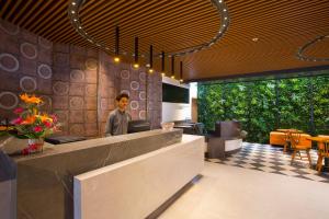 a man standing at a counter in a restaurant at Fountain Tree by TGI in Bangalore