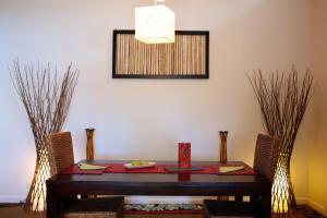 a dining room table with a vase of flowers on it at Healesville Apartments in Healesville