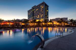 a large swimming pool with a building in the background at Swandor Cam Ranh Resort-Ultra All Inclusive in Cam Ranh