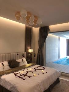 a bedroom with a bed with candles on it at Han River Chalets in Taif