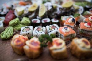 a table topped with sushi and other food items at Head over Hills in Knysna