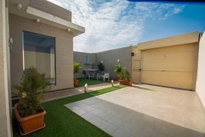 a backyard of a house with a garage at Han River Chalets in Taif