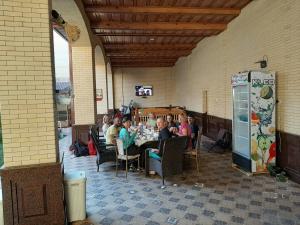 a group of people sitting at a table in a room at Like Guest House in Samarkand