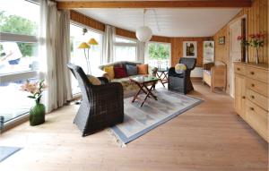a living room with a couch and chairs and a table at Holiday Home Hvide Sande 48 in Bjerregård +11 photos