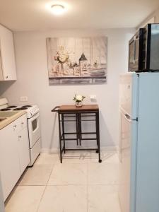 a kitchen with a table and a refrigerator at Guayabita's House in Miami