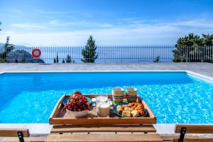 a tray of food sitting next to a swimming pool at Ble on Blue in Athani