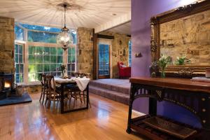 a dining room with a table and a large mirror at Bluegums Retreat in Hepburn Springs