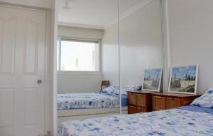 a bedroom with two beds and a mirror at Rachel imenu Duplex Apartment Amazing sea view in Ashdod
