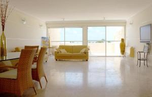 a living room with a yellow couch and a table at Rachel imenu Duplex Apartment Amazing sea view in Ashdod