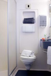 a small bathroom with a toilet and a sink at Kyriad Direct Macon Sud in Crêches-sur-Saône