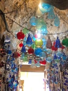 a bunch of glass bells hanging from a ceiling at Hebron Hope Guesthouse in Hebron
