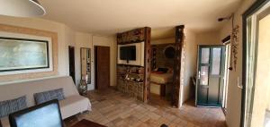 a living room with a couch and a tv at Studio-apartments Monfort in Portorož