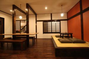 a living room with a wooden floor and wooden furniture at HOSTEL MICHIKUSA-YA in Fujikawaguchiko
