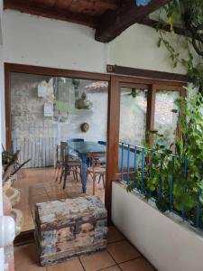 a patio with a table and a glass door at El Cuetu in Posada