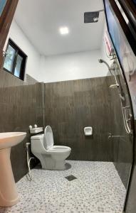 a bathroom with a toilet and a sink at Kobe's Beachfront Haven in Siquijor +101 photos