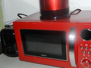 a red microwave with a cup on top of it at Klassik and sunny Apartment! in Vienna