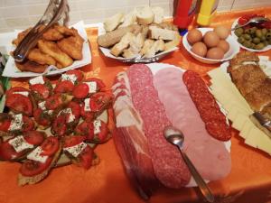 a table topped with meats and cheese and other appetizers at Djurovic Apartments Montenegro in Kotor