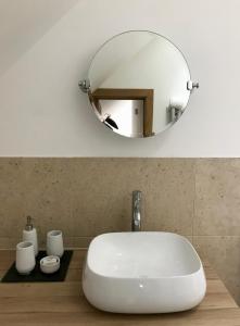 a bathroom with a white sink and a mirror at The Acorns in Marlow