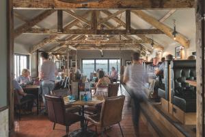 a group of people sitting at tables in a restaurant at Chainlocker in Falmouth