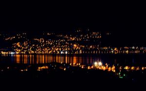 a view of a city at night with the water at Four Bedrooms Villa Anita in Polje