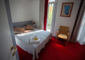 a bedroom with a bed with a tray of food on it at Hôtel restaurant Oasis in Nice