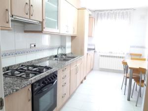 a kitchen with a sink and a stove top oven at Precioso Duplex Cal Richi in Tremp +18 photos