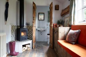 a bathroom with a wood burning stove in a room at Artist Residence Oxfordshire in Oxford