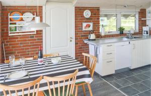 a kitchen with a black and white striped table and chairs at Three-Bedroom Holiday Home In Hadsund in Haslevgårde