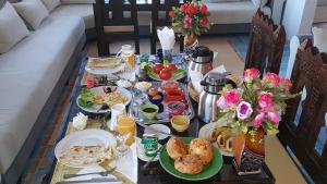 a table with plates of food on it at Hotel New Mars Dades in Aït Idaïr