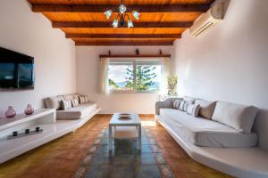 a living room with a couch and a table at Orizontes Boutique Studios in Adamantas