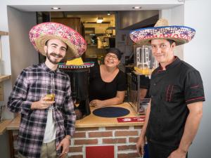 two men wearing sombrell hats standing in a kitchen at Eurohostel in Helsinki