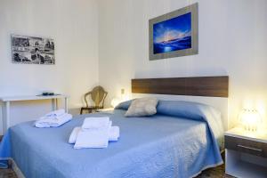 Postel nebo postele na pokoji v ubytování Don Alfonso Apartaments