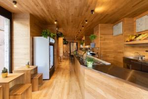 a kitchen with a long counter and wooden walls at Chapter Roma in Rome