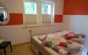 1 dormitorio con 2 camas, espejo y ventanas en Ferienwohnung Apartement am Wolfsberg, en Reinhardtsdorf