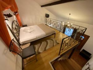 a small room with a bed and a staircase at Hanul Fullton in Cluj-Napoca