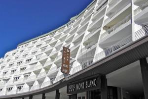 a large white building with a sign on it at Precioso Apartamento en la plaza in Sierra Nevada