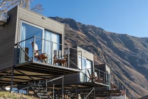 a house being built on top of a mountain at Landscapes Hotel Kazbegi in Kazbegi