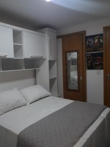 a bedroom with a large white bed and a door at WEST FLAT MOSSORÓ in Mossoró +73 photos