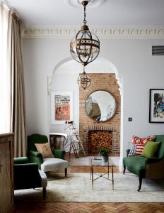 a living room filled with furniture and a painting on the wall at Artist Residence London in London