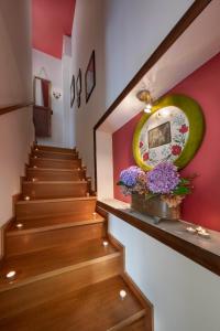 a stairway with a green mirror and purple flowers at Hotel Petradi in Kalamaki