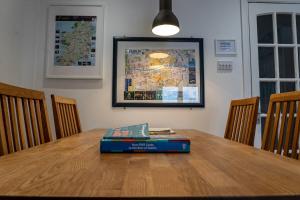 a book sitting on top of a wooden table at Liberty Townhouses in Dublin