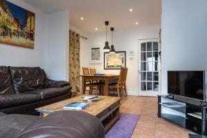 a living room with a couch and a table at Liberty Townhouses in Dublin