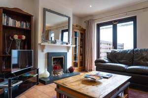 a living room with a couch and a fireplace at Liberty Townhouses in Dublin