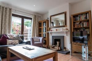 a living room with a coffee table and a fireplace at Liberty Townhouses in Dublin