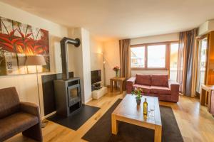 a living room with a couch and a fireplace at Apart Holidays - Marina Walensee in Unterterzen