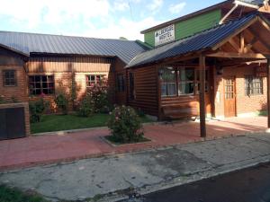 a building with a sign on the front of it at Hostel Buenos Aires in El Calafate