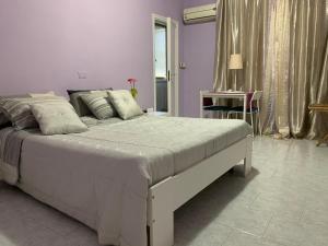 a bedroom with a large white bed in a room at Albergo Lamanna in Taranto