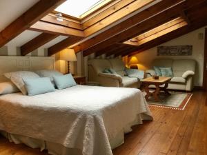 a bedroom with a bed and a living room at Posada La Llosa de Somo in Somo