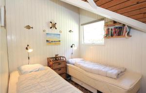 a bedroom with two beds and a window at Gorgeous Home In Hvide Sande With Wifi in Havrvig